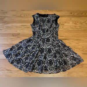 Danny & Nicole Black and White Women’s Lined Lace Dress with Back Gold Zipper.